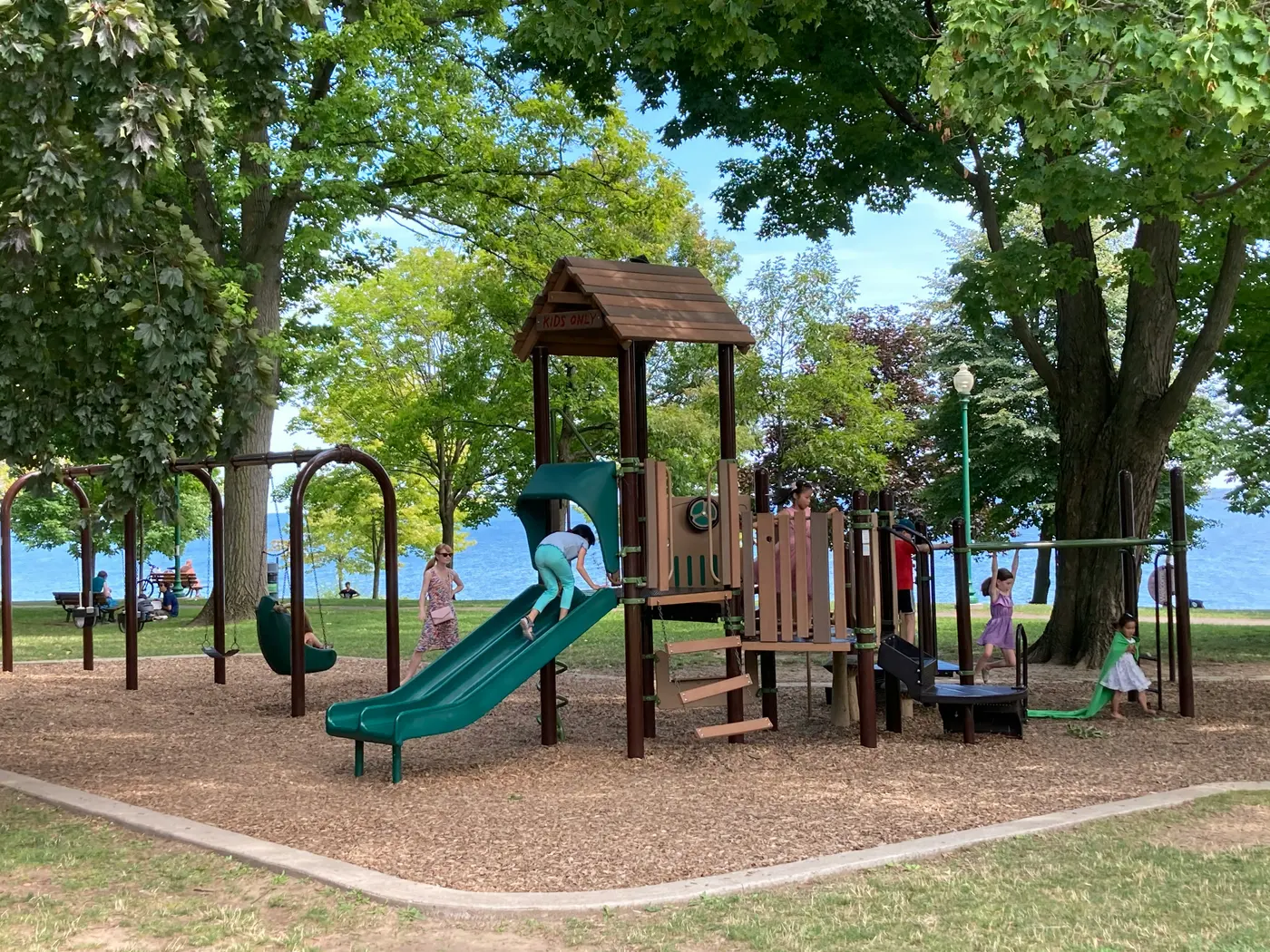 Children playing on a lakeside playground in Ontario